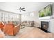 Comfortable living room with a fireplace, ceiling fan, neutral colors, and ample natural light at 2024 Linn Cv, Waxhaw, NC 28173