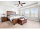Spacious main bedroom with tray ceiling, a ceiling fan, and large windows at 2024 Linn Cv, Waxhaw, NC 28173