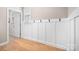 Mud room with board and batten detail, coat hooks and hardwood floors at 2024 Linn Cv, Waxhaw, NC 28173