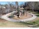 Community playground with slides, climbing structures, picnic tables, and a bench for relaxing at 2024 Linn Cv, Waxhaw, NC 28173