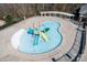 Community kiddie pool with colorful play structures, slides, and a relaxing splash pad area at 2024 Linn Cv, Waxhaw, NC 28173