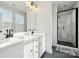 Bright bathroom features a double sink vanity, ample lighting, and a glass-enclosed shower at 2132 Electric Ln, Charlotte, NC 28205