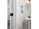 Bathroom features a pedestal sink with black faucet and an octagonal mirror at 2132 Electric Ln, Charlotte, NC 28205