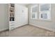 Bedroom with built-in murphy bed, shelving, and window with blinds at 2132 Electric Ln, Charlotte, NC 28205