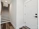Bright hallway featuring staircase with hardwood treads, and a white paneled entry door at 2132 Electric Ln, Charlotte, NC 28205