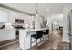 Bright kitchen features white cabinets, quartz countertops, stainless steel appliances, and island seating at 2132 Electric Ln, Charlotte, NC 28205