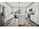 Modern kitchen with stainless steel appliances, white cabinets, and a center island at 2132 Electric Ln, Charlotte, NC 28205