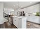 Open kitchen with stainless steel appliances and a view into the living and dining area at 2132 Electric Ln, Charlotte, NC 28205