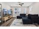 Bright living room featuring hardwood floors, recessed lighting, and a stylish sectional couch at 2132 Electric Ln, Charlotte, NC 28205