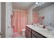 Well-lit bathroom featuring double sinks, a large mirror and a shower with a pink patterned curtain at 2598 Bryant Dr, Fort Mill, SC 29707