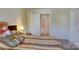 Cozy bedroom with striped bedding, carpeted floors and an open doorway leading to an adjacent room at 2598 Bryant Dr, Fort Mill, SC 29707