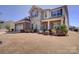 Charming two-story home with stone and brick exterior, landscaped yard, and attached two-car garage at 2598 Bryant Dr, Fort Mill, SC 29707