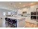Modern kitchen boasts stainless steel appliances, granite countertops, and bar stool seating at 2598 Bryant Dr, Fort Mill, SC 29707