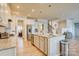 Bright, open kitchen with stainless appliances, island and view of the upper level at 2598 Bryant Dr, Fort Mill, SC 29707