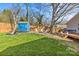 Spacious backyard with a blue shed, fire pit, patio seating, and inviting wood deck for relaxation and entertainment at 2911 N Myers St, Charlotte, NC 28205