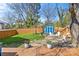 Well-maintained backyard with a wooden fence, shed, firepit and patio at 2911 N Myers St, Charlotte, NC 28205