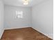 Clean, bright bedroom features wood floors and a window, creating a peaceful and inviting space at 2911 N Myers St, Charlotte, NC 28205