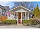 Charming home featuring a welcoming front porch, mature landscaping, and a well-manicured lawn at 2911 N Myers St, Charlotte, NC 28205