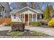 Charming home featuring a welcoming front porch, mature landscaping, and a well-manicured lawn at 2911 N Myers St, Charlotte, NC 28205