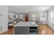 Open-concept living and dining area with a kitchen island, stylish furnishings, and plenty of natural light at 2911 N Myers St, Charlotte, NC 28205
