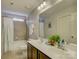 Bathroom featuring double sinks, white cabinets, and a shower-tub combination at 3308 Oscar Dr, Matthews, NC 28105