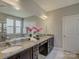 Bathroom showcasing double sinks, granite countertops, and a soaking tub beneath a window at 3308 Oscar Dr, Matthews, NC 28105