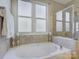 Bright bathroom featuring a soaking tub, a glass-enclosed shower, and a neutral color palette at 3308 Oscar Dr, Matthews, NC 28105