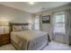 Bedroom with neutral decor, large windows, and comfortable bedding at 3308 Oscar Dr, Matthews, NC 28105