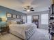 Bedroom with a beautiful bed, stylish lamps, and lots of natural light at 3308 Oscar Dr, Matthews, NC 28105