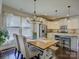 Bright dining area with view into kitchen, featuring a wood table and natural light at 3308 Oscar Dr, Matthews, NC 28105