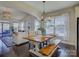 Bright and airy dining room featuring a large wood table and a view into the living room at 3308 Oscar Dr, Matthews, NC 28105