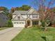 Charming two-story home boasts stone accents, a two-car garage, and a well-manicured lawn at 3308 Oscar Dr, Matthews, NC 28105