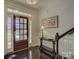 Inviting foyer with hardwood floors, a decorative table, and a staircase at 3308 Oscar Dr, Matthews, NC 28105