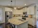 A modern kitchen features stainless steel appliances, a granite island with seating, and ample storage at 3308 Oscar Dr, Matthews, NC 28105