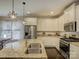 Bright kitchen boasts stainless appliances, granite countertops, island sink, and white cabinets at 3308 Oscar Dr, Matthews, NC 28105