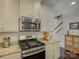 Close-up of kitchen features stainless steel microwave and oven, granite countertops, and white cabinets at 3308 Oscar Dr, Matthews, NC 28105