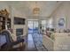 Cozy living room with fireplace, vaulted ceilings, and sliding door access to backyard at 3308 Oscar Dr, Matthews, NC 28105