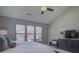 Spacious main bedroom with a vaulted ceiling, a ceiling fan, and large windows for natural light at 3308 Oscar Dr, Matthews, NC 28105
