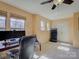 Bright office space with neutral tones, multiple windows, ceiling fan, and built-in desk setup at 3308 Oscar Dr, Matthews, NC 28105