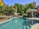 A luxurious backyard oasis with a pool, tanning deck, and screened in porch for outdoor enjoyment at 3308 Oscar Dr, Matthews, NC 28105