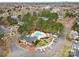 Aerial view of a community pool and clubhouse surrounded by trees and parking areas at 3643 Melrose Cottage Dr, Matthews, NC 28105