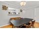 Dining room with hardwood floors, chandelier, and a pass-through to the kitchen, perfect for entertaining at 3643 Melrose Cottage Dr, Matthews, NC 28105