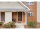 Close-up of a well-maintained front door with brick and siding, enhanced by stylish landscaping and a welcoming entrance at 3643 Melrose Cottage Dr, Matthews, NC 28105