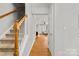 Inviting hallway with hardwood floors and staircase, showcasing a view into the living area for an open feel at 3643 Melrose Cottage Dr, Matthews, NC 28105