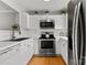 Bright kitchen featuring white cabinets, stainless steel appliances, and hardwood floors, blending style and functionality at 3643 Melrose Cottage Dr, Matthews, NC 28105