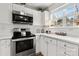 Bright kitchen featuring white cabinets, stainless steel appliances, complemented by stylish decor and natural light at 3643 Melrose Cottage Dr, Matthews, NC 28105