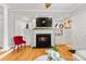 Bright living room with fireplace, built-in shelves, and hardwood floors at 3643 Melrose Cottage Dr, Matthews, NC 28105