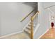 Carpeted staircase with wood railing leading to the upper level at 3643 Melrose Cottage Dr, Matthews, NC 28105