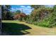 Expansive backyard featuring a lush lawn surrounded by mature trees, providing a serene outdoor setting at 3808 22Nd Street Ne Ct, Hickory, NC 28601