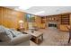 Finished basement with wood paneled walls, a brick fireplace, and a comfortable seating area at 3808 22Nd Street Ne Ct, Hickory, NC 28601